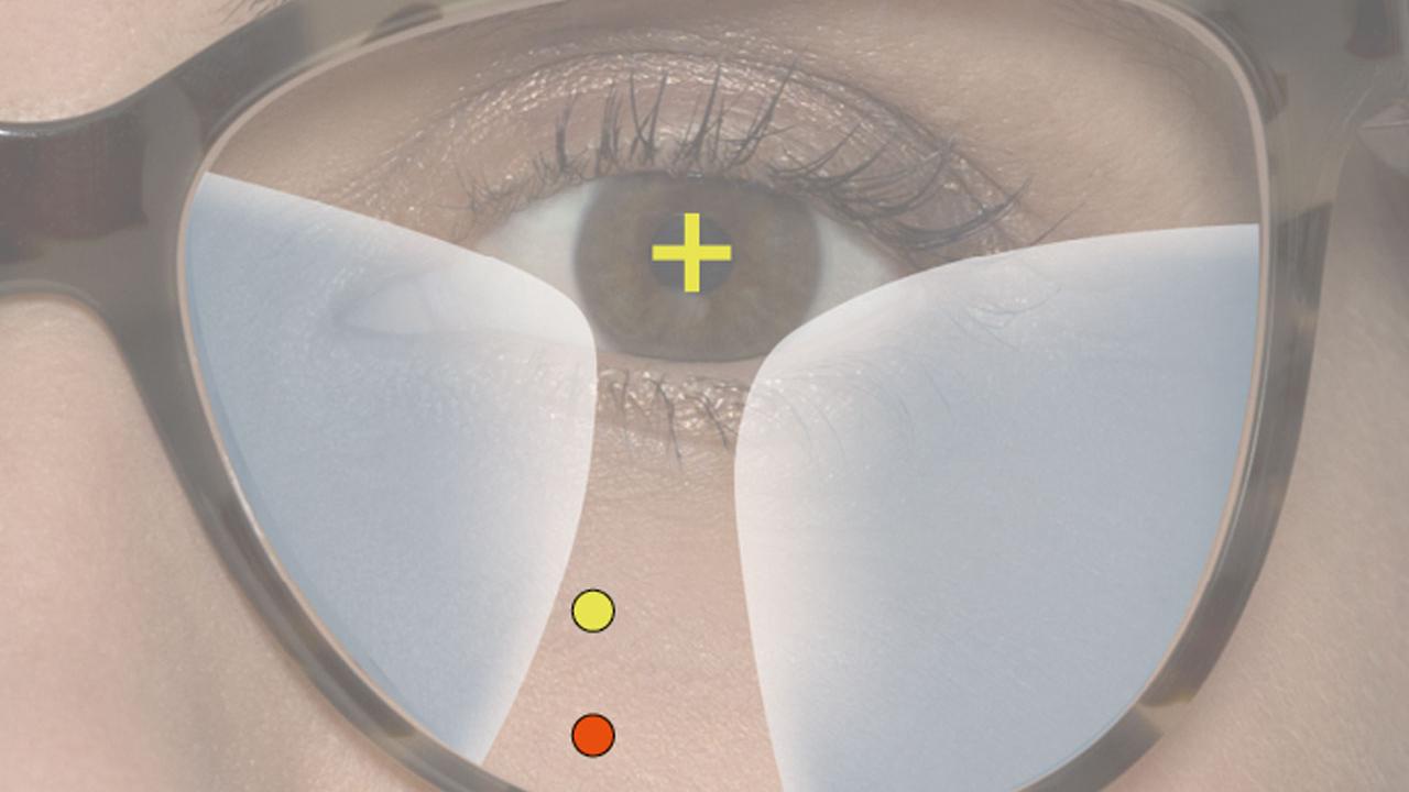 Com sua nova armação maior e lentes progressivas convencionais, você olha através de uma área (ponto vermelho) situada muito abaixo na lente, o que exige uma alteração dos seus hábitos de visão.