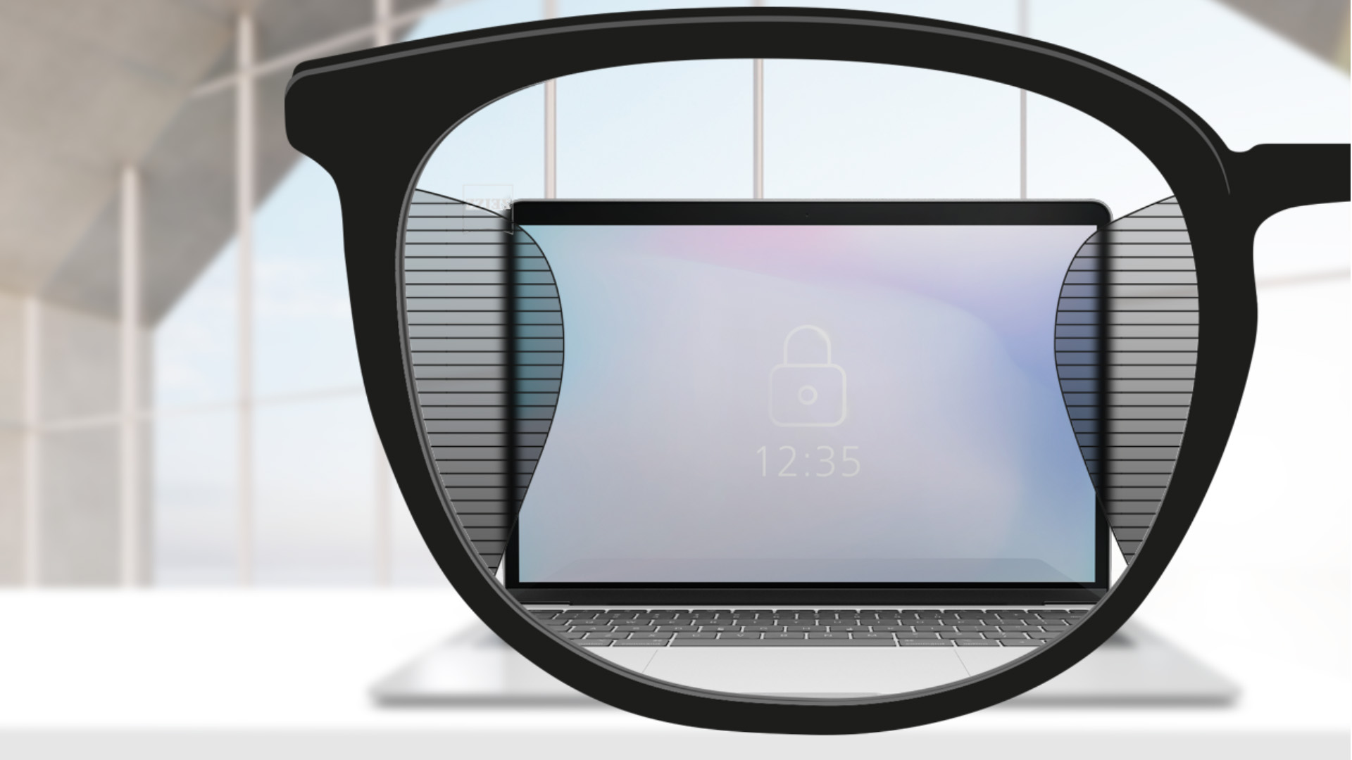 Imagem do ponto de vista de lentes ZEISS Office com uma tela de computador no centro da lente e linhas finas e desfocadas à direita e à esquerda.