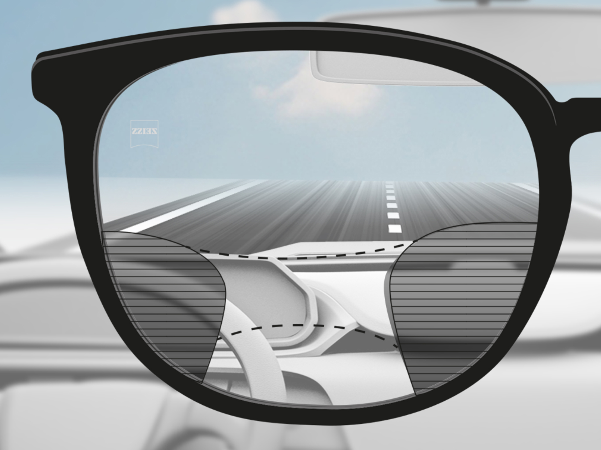 Imagem do campo de visão através de uma lente progressiva ZEISS DriveSafe: as zonas de visão são adaptadas para que o motorista tenha zonas de visão nítidas na estrada e no painel.