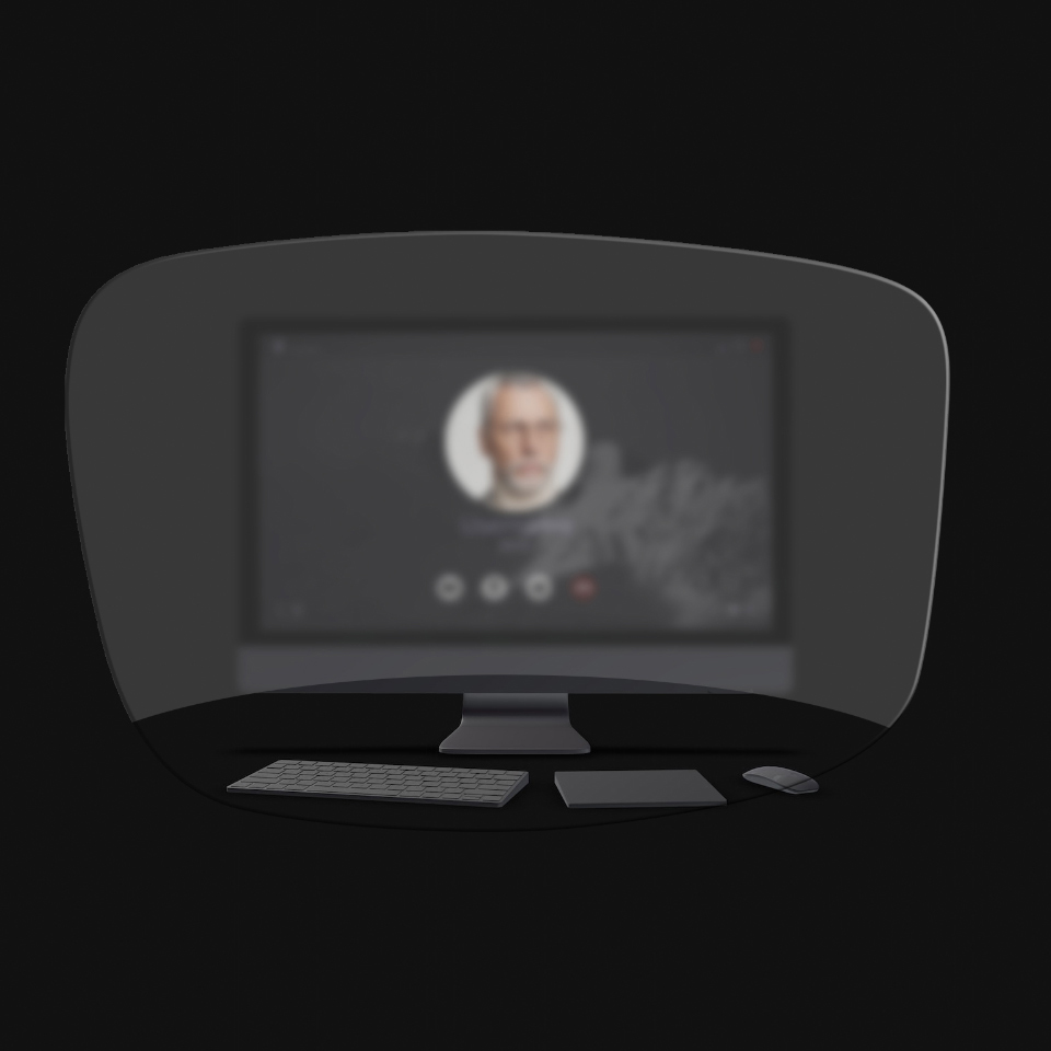 A visão de um computador, teclado, mouse e livro através de uma ilustração esquemática de óculos de leitura mostra que somente os objetos próximos estão nitidamente visíveis. A tela do computador está desfocada.